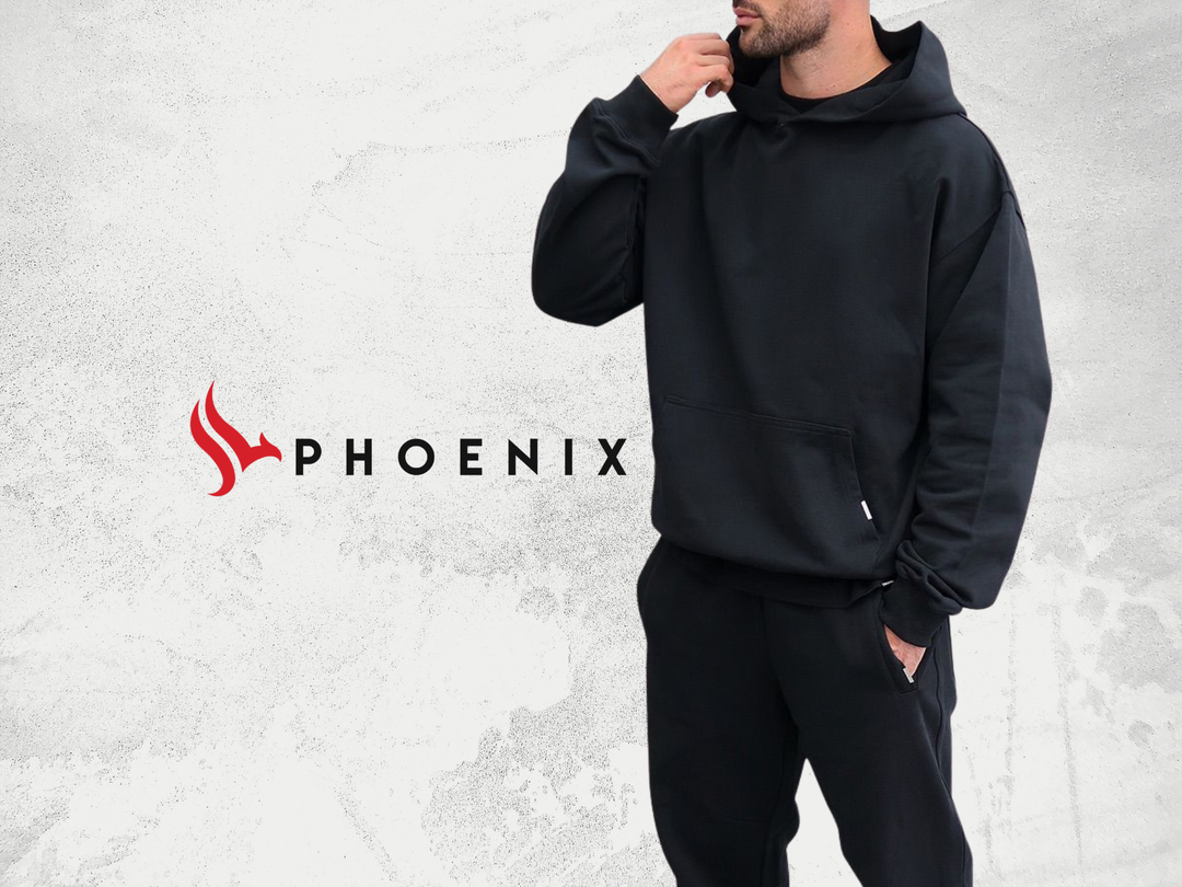 Man wearing black hoodie and black pants set, casual streetwear with Phoenix logo in background