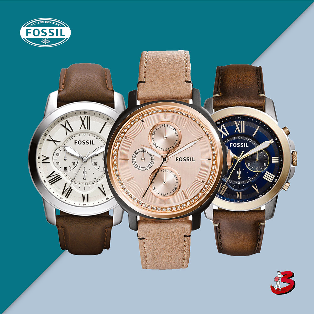 Three Fossil watches with leather straps in white, rose gold, and blue dials on a two-tone background