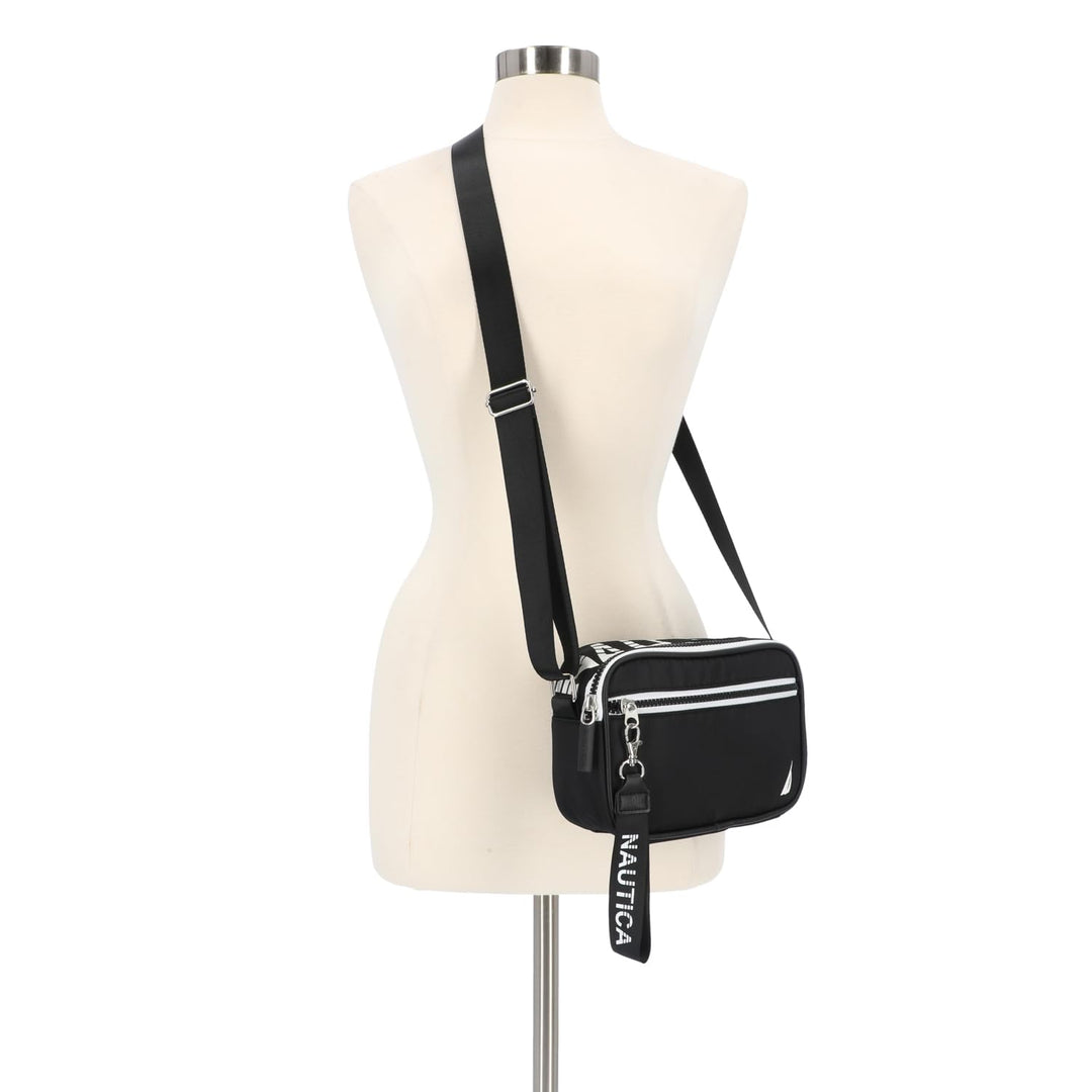 Black crossbody bag on a mannequin with &