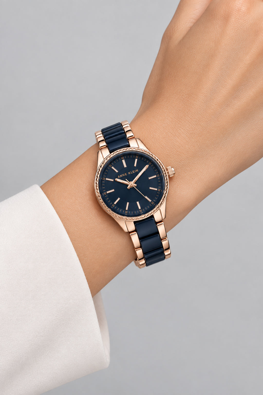 Anne Klein women's watch featuring a round rose gold-tone case, a dark navy blue dial, and a matching dark blue and rose gold link bracelet.